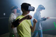 Young boy wearing VR headset and playing games with his family.