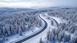 Winter snowy view of remote dual carriageway surrounded by snow and forest
