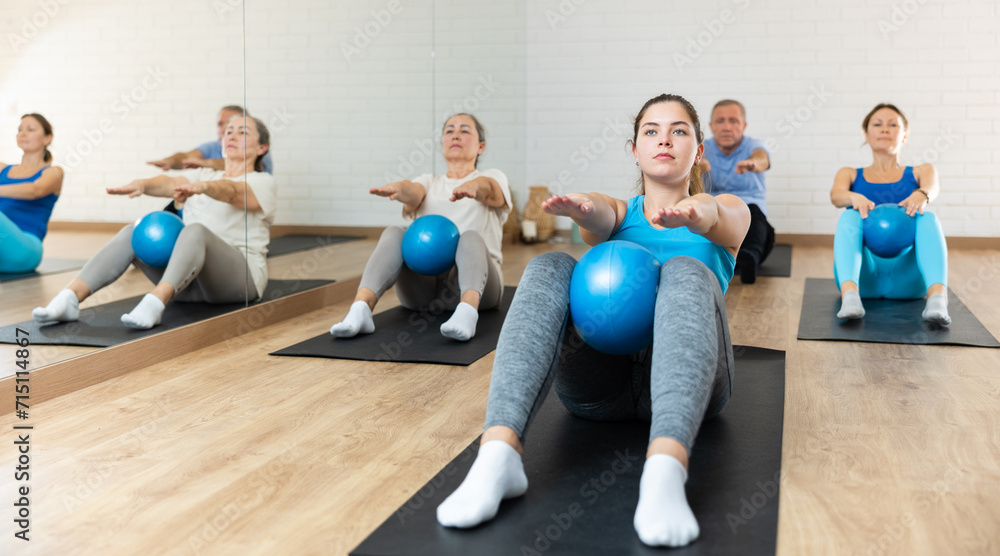 Sporty young girl doing sit-ups with bender ball to strengthen abs ...