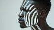 African man with traditional style face paint .