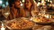 A couple enjoying pasta and wine in a restaurant