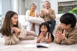© Art_Photo - Portrait happy love asian family father and mother teach little daughter asian girl learn and study.Mom and asian young girl reading book making lessons in homeschool at home.Education