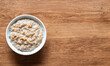 oatmeal in a white bowl on wooden surface
