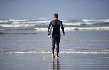 Poster - Ocean, surfing and man with surfboard at beach for waves on summer vacation, weekend and holiday by sea. Travel, nature and back of person running for water sports, adventure and hobby in Australia