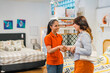© Odua Images - female shop assistant shaking hands with female customer after buying a sofa at a furniture store
