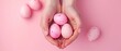 Woman's hands gently cradle a pastel pink painted Easter egg, Ai Generated.