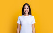 Woman isolated on yellow. Millennial woman wearing white tshirt. Casual style of millennial woman. Portrait of young woman in casual style tshirt in yellow studio
