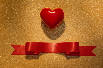 Poster - Red heart with ribbon on golden glitter texture. Valentine's Day background