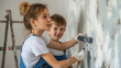 © Keitma - Mother and son engaged in home room wall painting using paint roller , family doing DIY energy efficiency renovation work of their house