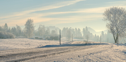 Wall Mural - Mountain road on an extremely cold morning, surface covered with ice and snow.