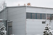 © AlexGo - A Large Industrial Warehouse Complex Covered in Snow Showcasing the Modern Architecture and Exterior Design