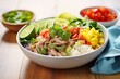 pulled pork burrito bowl with ingredients deconstructed