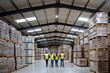 © Halfpoint - Rear view of warehouse workers walking in warehouse. Team of warehouse workers preparing products for shipment.