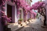 Fototapeta  -  a cobblestone street lined with potted plants next to a building with pink flowers growing on the side of it.