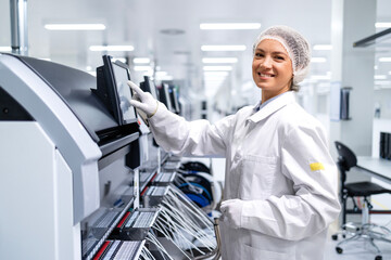 Wall Mural - Portrait of female employee working in automobile industry assembly line.