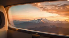 The Ethereal Beauty Of A Sunset Over Majestic Mountains, As Seen Through The Impeccably Clean Window Of A Private Jet.