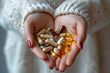 Woman's hands holding different pills. Dietary and nutritional food supplements and vitamins. Capsules for healthy lifestyle.