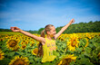 © Westend61 - Happy girl with arms outstretched in sunflower field