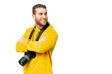 Poster - Young photographer man over isolated chroma key background with arms crossed and happy