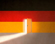 © Westend61 - German flag with light of opportunity behind ajar door to immigrate in Germany
