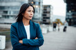 © Westend61 - Businesswoman standing with arms crossed in office park