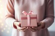 © m - Close-up woman hands holding gift box, present surprise, Festive, celebration, pink, congratulation. Valentine's day. LGBT, homosexual, friends relationship, lesbian couple. Love and care