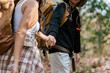© itchaznong - Happy LGBT Lesbian couple Travelers Hiking with Backpacks in forest Trail. LGBT Lesbian Couple Hikers with backpacks walks in mountains in vacation