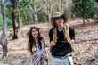 © itchaznong - Happy LGBT Lesbian couple Travelers Hiking with Backpacks in forest Trail. LGBT Lesbian Couple Hikers with backpacks walks in mountains in vacation