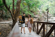© itchaznong - Happy LGBT Lesbian couple Travelers Hiking with Backpacks in forest Trail. LGBT Lesbian Couple Hikers with backpacks walks in mountains in vacation