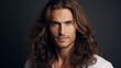 © ALA - Handsome elegant sexy smiling Caucasian man with perfect skin and long hair, on a silver background, banner, close-up.