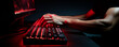 A concentrated gamer plays a game using a backlit mechanical keyboard, in a dark room, with a monitor in the background. Gamification. Cybersports competition and gaming technology