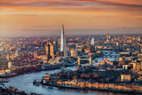 Fototapeta Londyn - Panoramic sunrise view of the London skyline with Tower Bridge and river Thames in soft sunlight, England