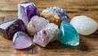 semi precious stones of different colors amethyst and amethyst druse crystals rose quartz agate uvarovite turquoise aquamarine rock crystal on a wooden background