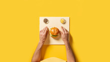 Highest Resolution, Modern Setup And Art Direction, Person Eating A Burger On An Empty Table Top View, Sitting In A Straight Posture