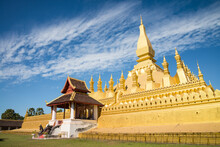 Beautiful Large Golden Pagoda Pha That Luang Temple Famous Landmark In Vientiane, Laos PDR Sunny Day Blue Sky Background. Travel Destination And Religion In Asia Concept.
