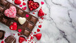 heart shaped chocolate candy. Valentines Day chocolate side border. Red and pink heart theme. Top down view on a white marble background with copy space
