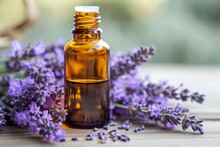 Bottle Of Lavender Essential Oil With Fresh Lavender Flowers On Wooden Table
