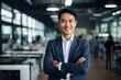 © JAYDESIGNZ - Happy confident asian american businessman in office looking at camera