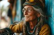 Portrait of old woman in a headband, with glasses, wearing bright colored informal psychedelic clothes in gypsy or hippie style. Concepts: wisdom, freedom. active longevity, health, ethnic flavor