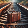 an old and reliable, large brown travel suitcase with straps that fasten, is always ready for travel and stands on the rails of the railway