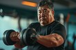 Fat middle aged asian man dumbbell exercising