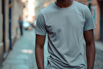 Wall Mural - Mockup Of A Man Wearing A Grey T-Shirt On The Street