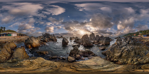 Wall Mural - full hdri 360 panorama view on ocean on shore with rocks at sunset with beautiful clouds in sky in e