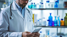Pharmaceutical Lab Worker Is Viewing Information On Tablet Indoors