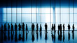 © Andrea Raffin - Business people in silhouette walking in an abstract urban background made of steel and glass.