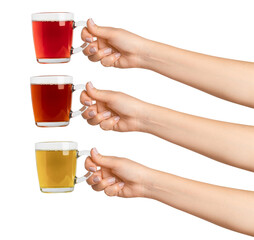 Wall Mural - Women's hands hold. Three cups of green, black and red tea tea in a transparent glass cup. On a blank background