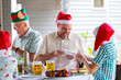 © Austockphoto - Family popping Christmas crackers at Christmas lunch table
