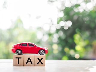 Canvas Print - Toy car and Wooden blocks with the word TAX . The concept for paying TAX for car in future