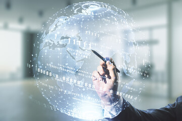 Man hand with pen working with abstract virtual coding concept and world map on blurred office background. Multiexposure
