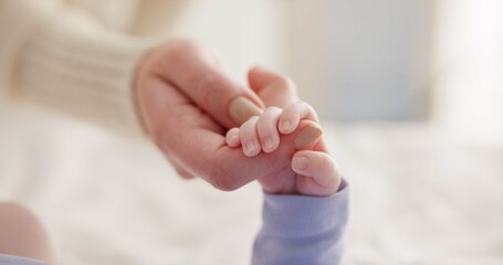 sleeping, family and holding hands with baby on bed for bonding, love and relationship with infant. 